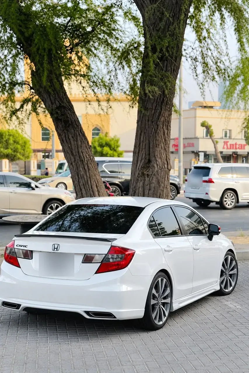 White Honda Civic — CarLift Sharjah to Dubai car lift Dubai